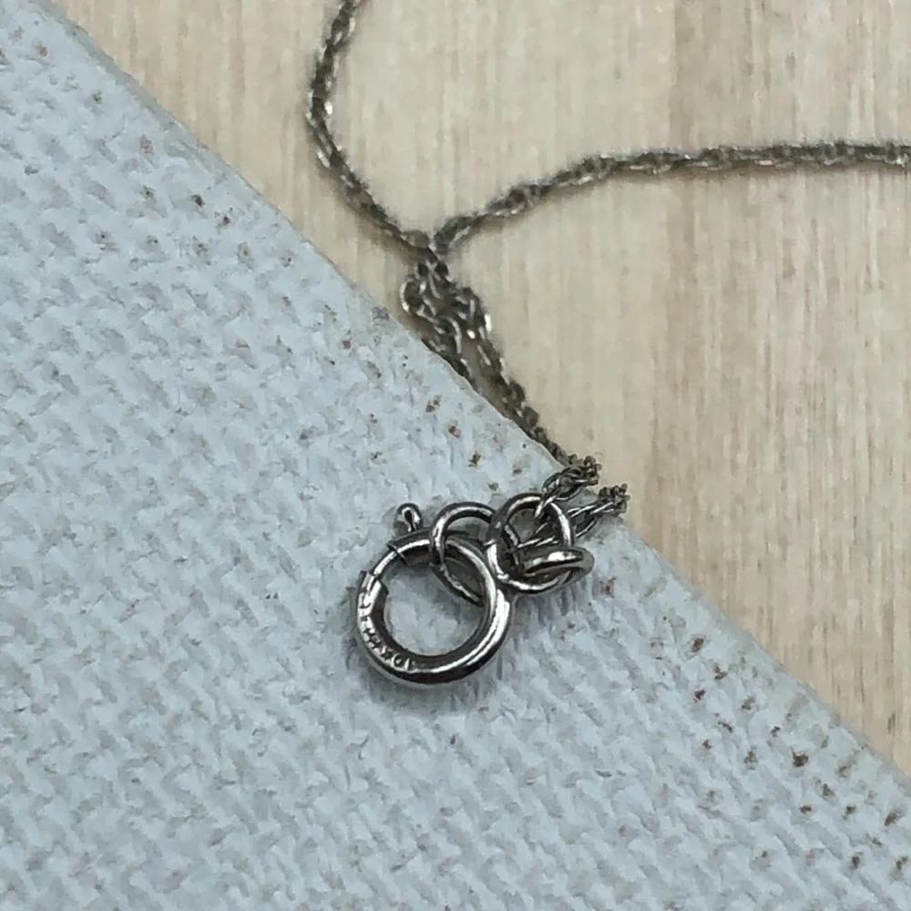 Solid 10k white gold multi baguette diamond wishbone pendant necklace.